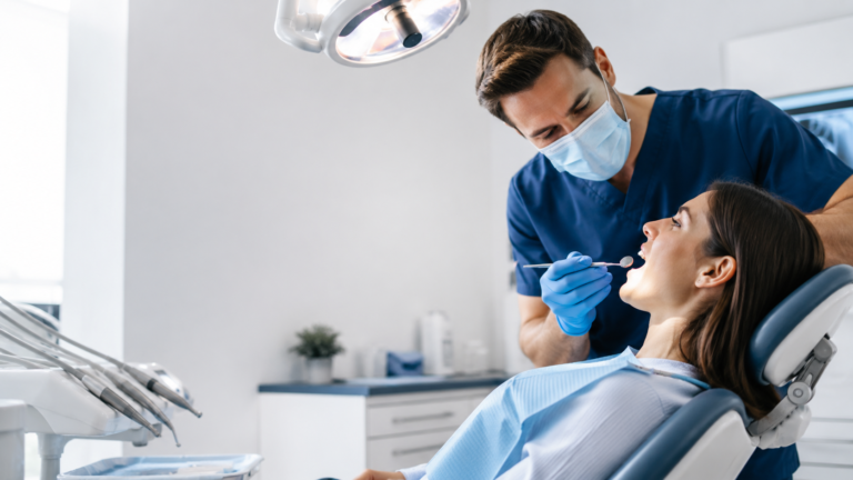 Dentist examining a patient during a dental appointment.